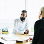 Client listening to project presentation in office conference room