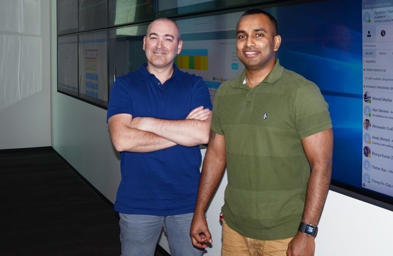 Eric and Gary standing in front of the projector screen.