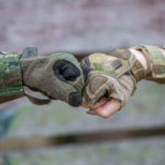Service members with different uniforms fist-bump.