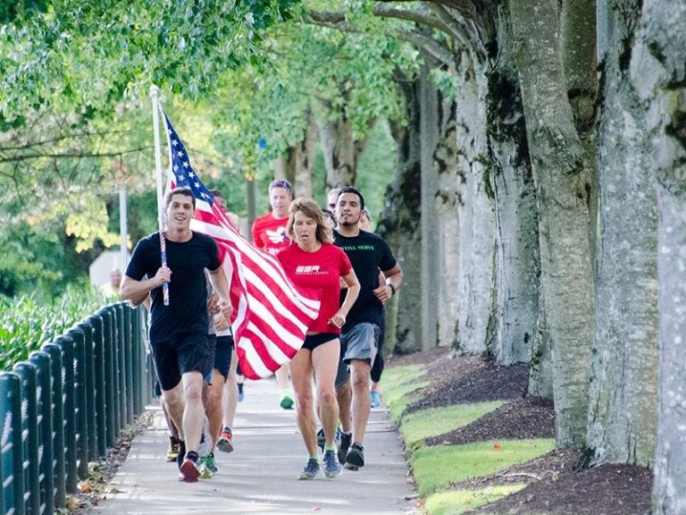 People running with the American flag as part of the Old Glory Relay.