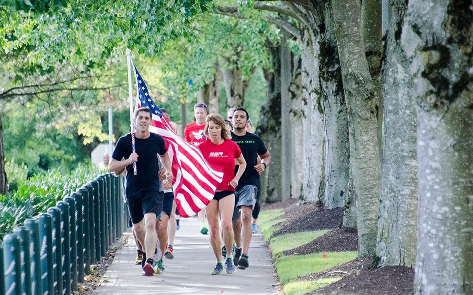 People running with the American flag as part of the Old Glory Relay.