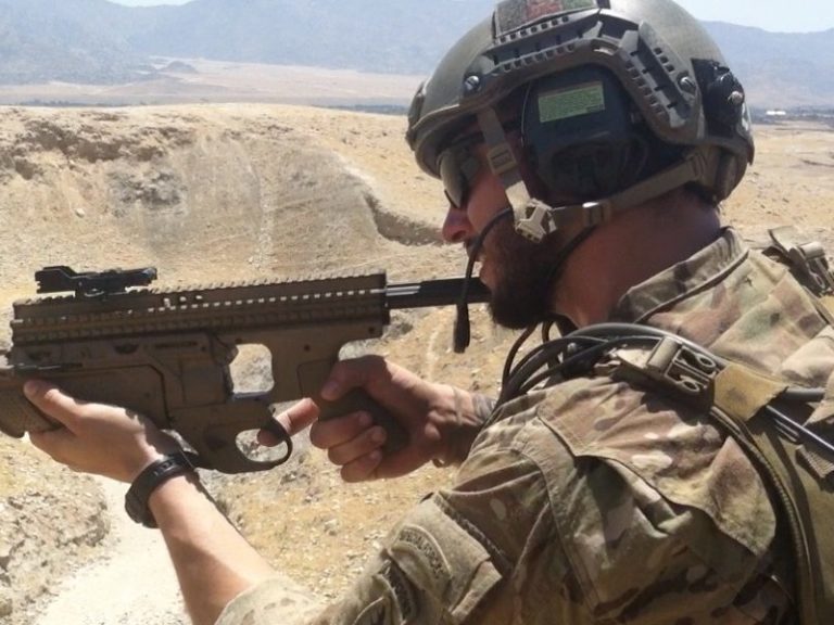 Special forces soldier overseas firing weapon.