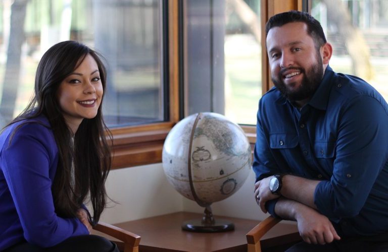 MSSA grads take a photo near a globe.