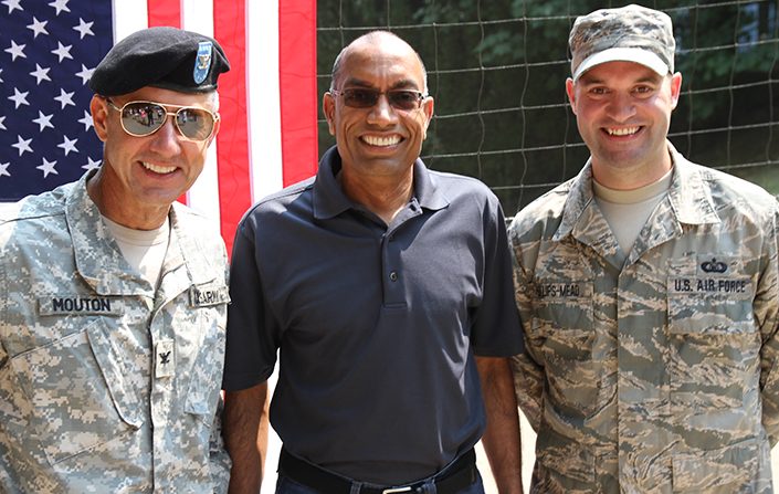 At a Microsoft company picnic on Lake Sammamish, Corporate Vice President Suresh Kumar (center) was on hand as Retired Army Col. Doug Mouton (left) administered the Oath of Enlistment to his Microsoft colleague, Staff Sgt. and Air Traffic Control Watch Supervisor Jesse Phillips-Mead (right).