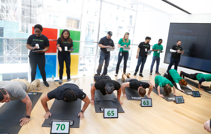 Contestants utilized technology for their pushup counters during the Microsoft Military Affairs Pushups for Charity event.