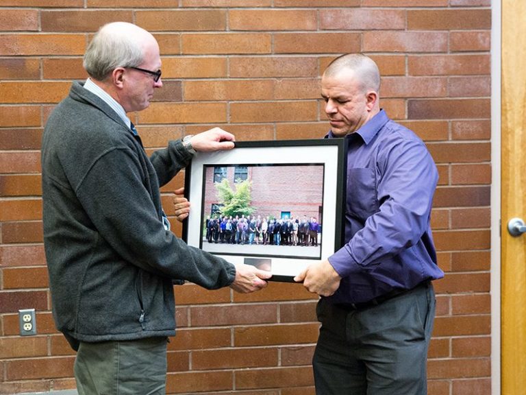 Robert Beare presenting a photo of the class to his MSSA instructor during graduation.
