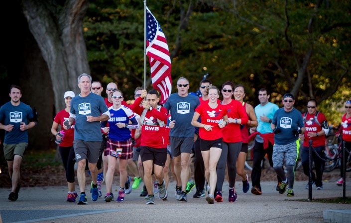 A group of RWB runners carrying the American flag for Old Glory Relays.