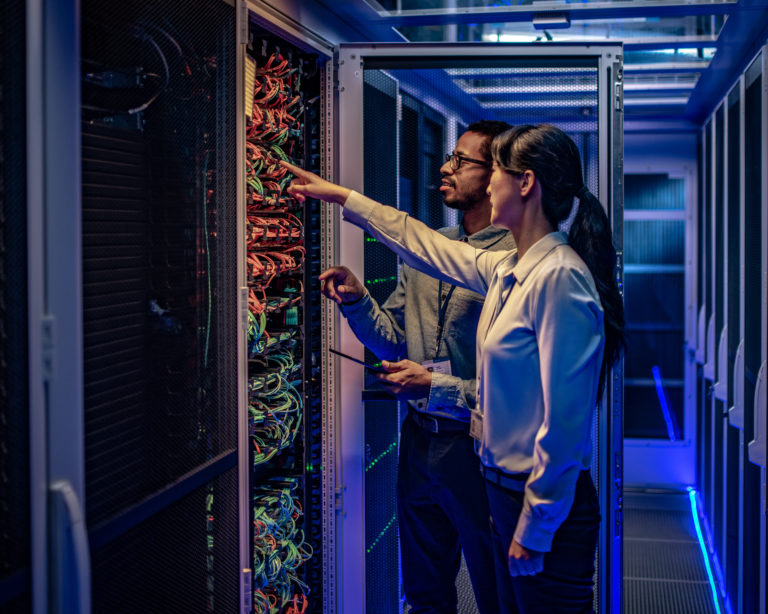 IT engineers checking servers in server room