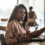 Portrait of young professional woman in coffee shop