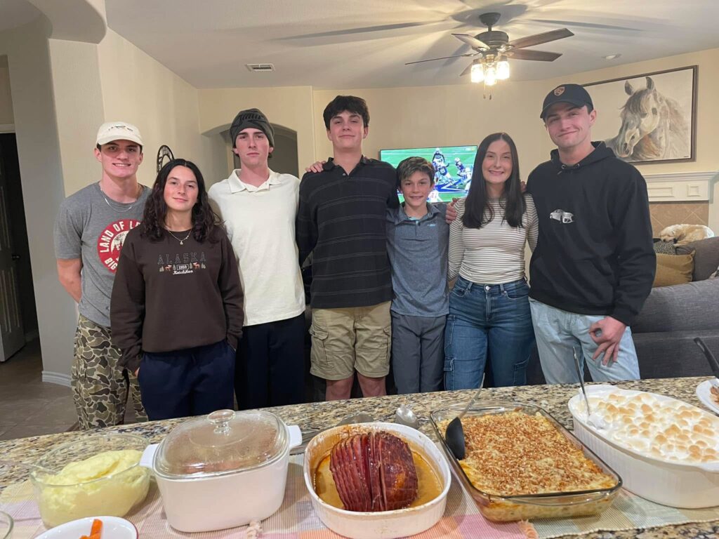 Microsoft software engineer and MSSA mentor Basia with her 6 kids in front of a full dining table